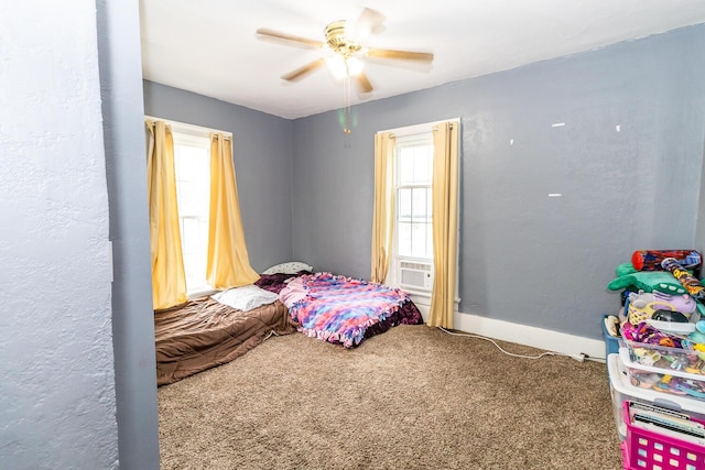 carpeted bedroom featuring baseboards, cooling unit, ceiling fan, and multiple windows