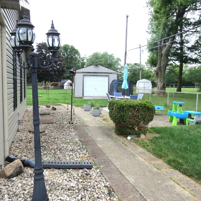 1084 Colonial Dr, Sidney, OH 45365 - view of yard featuring a storage unit and a garage