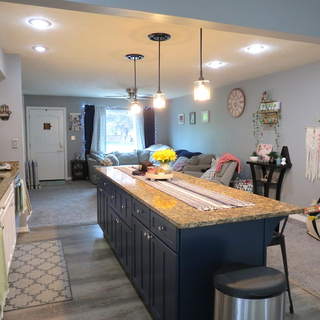 1084 Colonial Dr, Sidney, OH 45365 - kitchen with open floor plan, a breakfast bar area, a center island, pendant lighting, and recessed lighting