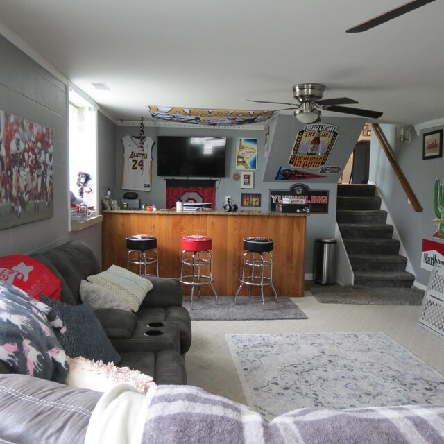 1084 Colonial Dr, Sidney, OH 45365 - living area with a dry bar, ceiling fan, and stairs