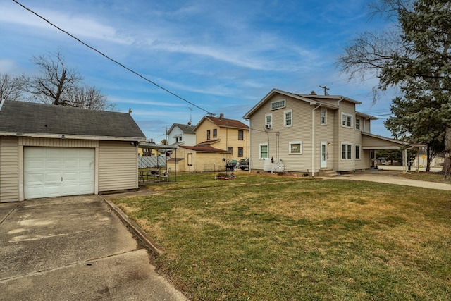 view of side of property with a garage, an outdoor structure, a carport, and a lawn