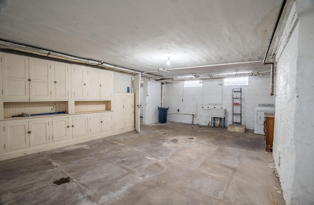 below grade area featuring a sink and washer / clothes dryer