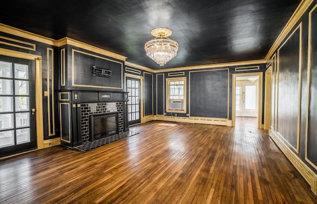 unfurnished living room with dark wood-style floors, baseboards, a notable chandelier, a baseboard radiator, and ornamental molding