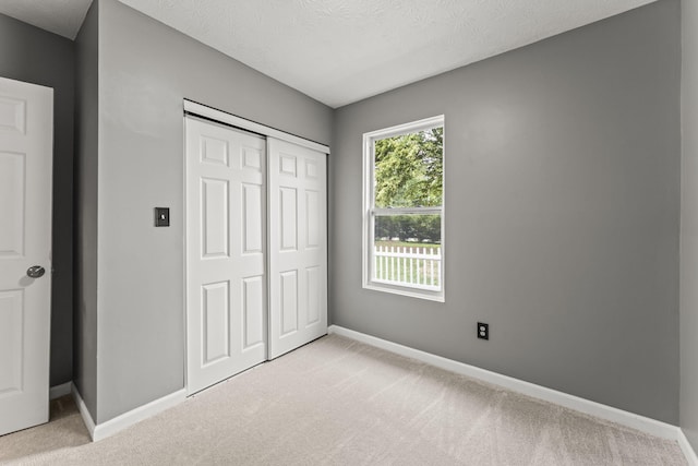3667 Randee Ln, Springfield, OH 45502 - unfurnished bedroom with light colored carpet, a closet, and a textured ceiling