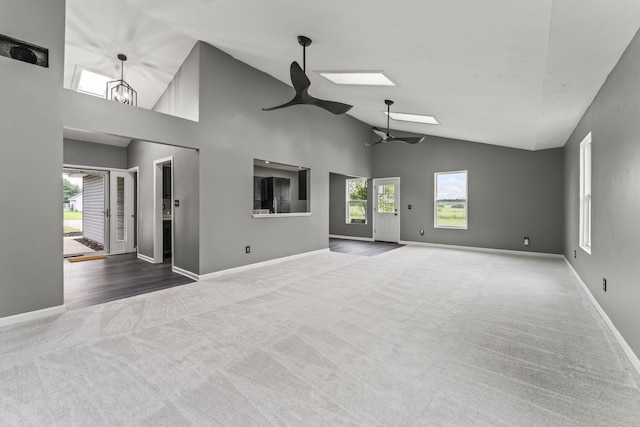 3667 Randee Ln, Springfield, OH 45502 - empty room with ceiling fan, carpet flooring, high vaulted ceiling, and a skylight