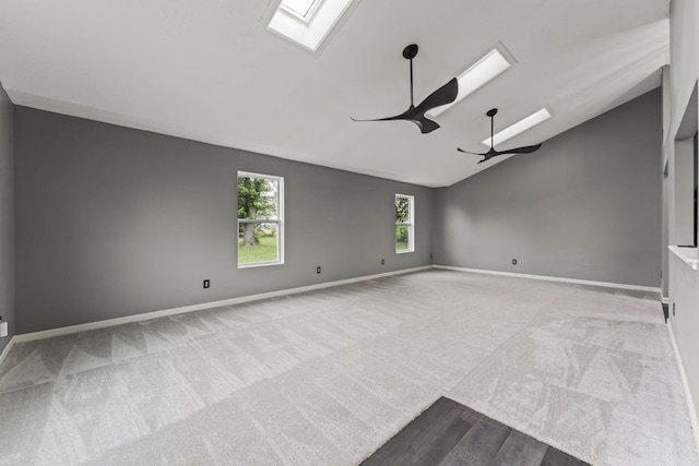 3667 Randee Ln, Springfield, OH 45502 - spare room featuring a skylight, ceiling fan, lofted ceiling, carpet, and wood finished floors