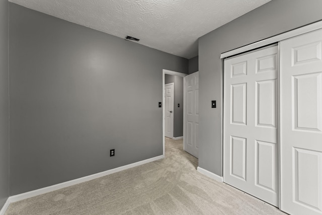 3667 Randee Ln, Springfield, OH 45502 - unfurnished bedroom with light carpet, a closet, and a textured ceiling