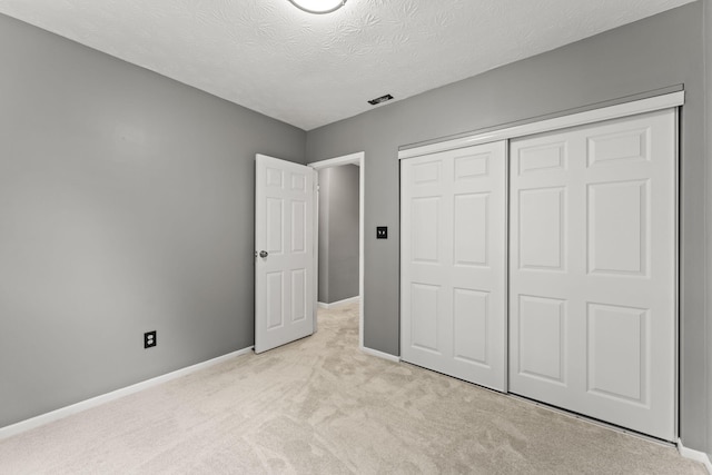 3667 Randee Ln, Springfield, OH 45502 - unfurnished bedroom with light carpet, a closet, and a textured ceiling