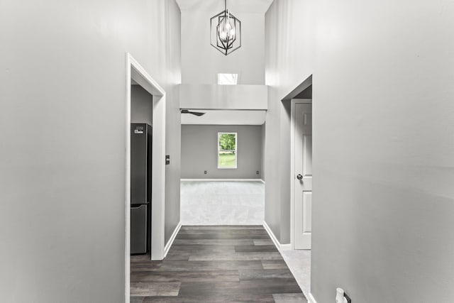 3667 Randee Ln, Springfield, OH 45502 - corridor featuring a high ceiling, a chandelier, and dark wood-style flooring