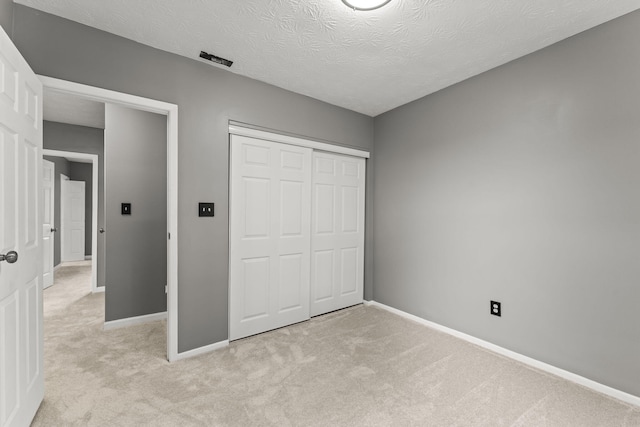 3667 Randee Ln, Springfield, OH 45502 - unfurnished bedroom with light carpet, a closet, and a textured ceiling