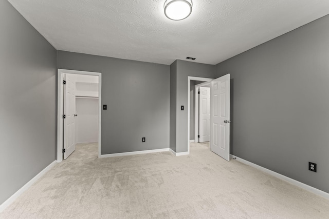 3667 Randee Ln, Springfield, OH 45502 - unfurnished bedroom with light colored carpet, a textured ceiling, and a spacious closet