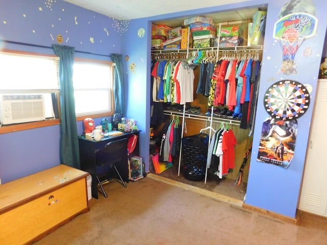 carpeted bedroom with cooling unit and a closet