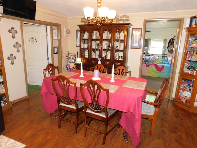 dining space featuring a notable chandelier and wood finished floors