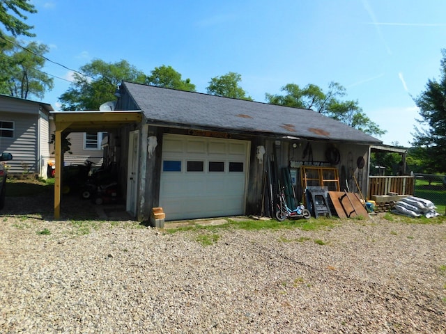 garage with a carport and driveway