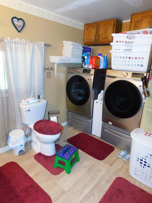 washroom with washer and clothes dryer, laundry area, and wood finished floors