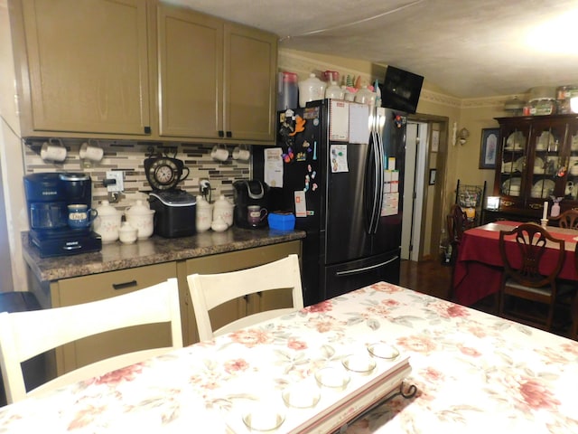 kitchen featuring backsplash and freestanding refrigerator