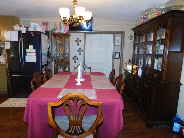 dining space featuring a chandelier and dark wood-type flooring