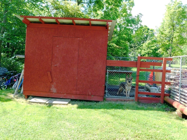 view of outbuilding with an outbuilding and fence