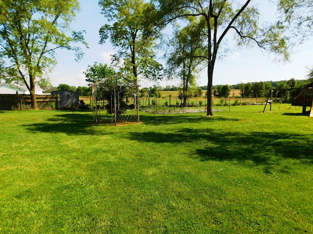 view of yard featuring fence and a playground