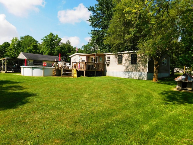 view of yard with an outdoor pool and a deck