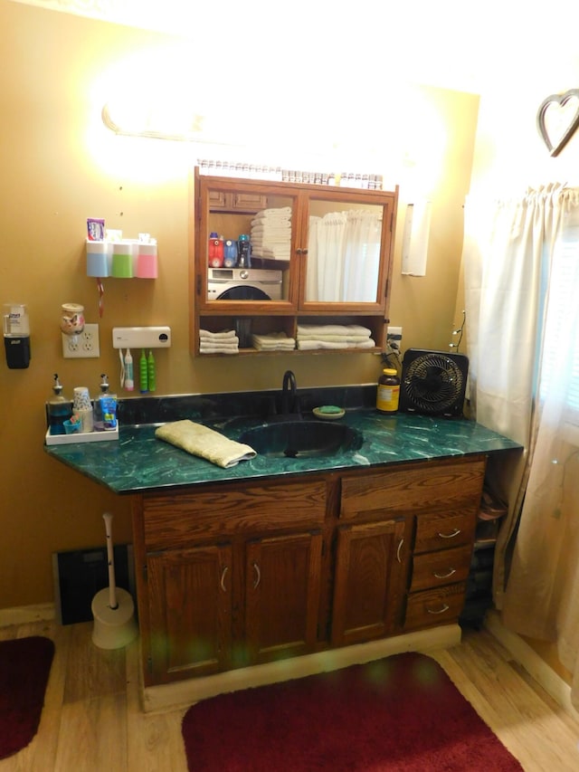 bathroom with vanity and wood finished floors