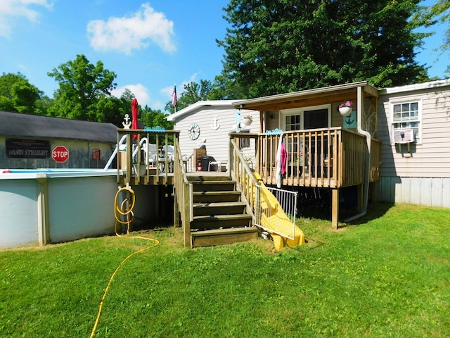 rear view of house featuring a deck, stairway, and a yard