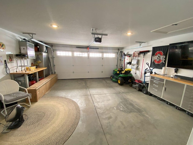 garage with water heater and a garage door opener