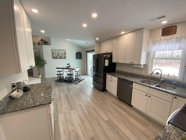 kitchen featuring light wood-style floors, white cabinets, a sink, and black appliances