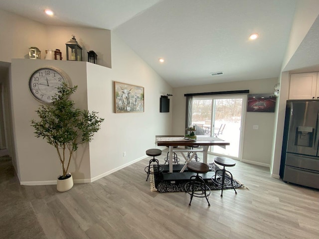 dining area featuring high vaulted ceiling, recessed lighting, visible vents, baseboards, and light wood-style floors