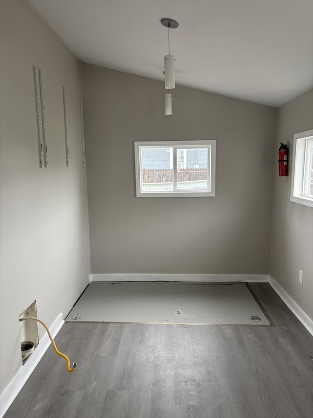 unfurnished room featuring baseboards and wood finished floors