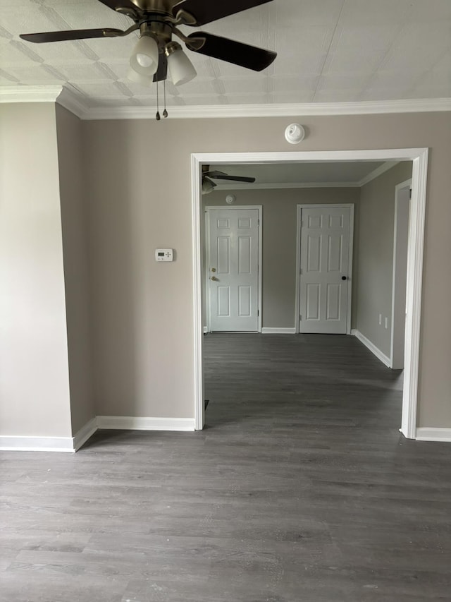 unfurnished room with a ceiling fan, baseboards, ornamental molding, and wood finished floors
