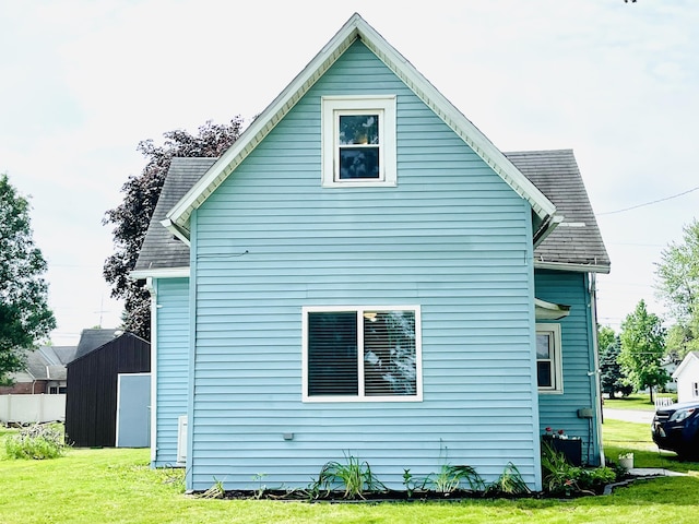 201 Clay St, Rockford, OH 45882 - view of home's exterior featuring a lawn and roof with shingles