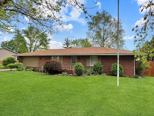 single story home with brick siding, an attached garage, fence, and a front yard