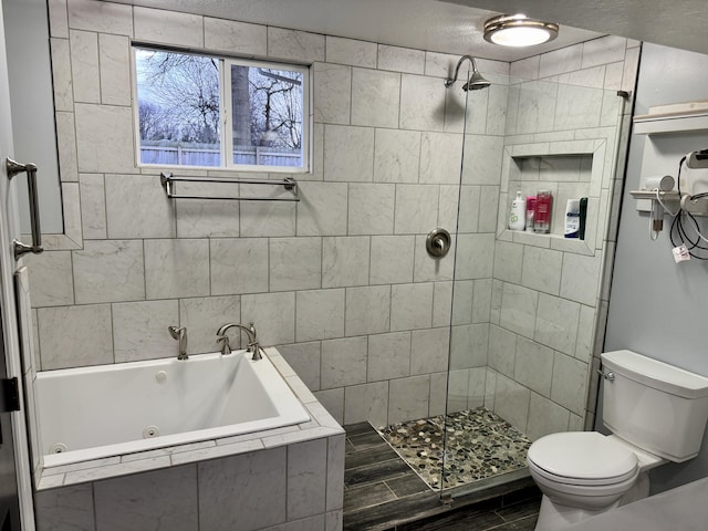 bathroom with toilet, a tub with jets, and a tile shower