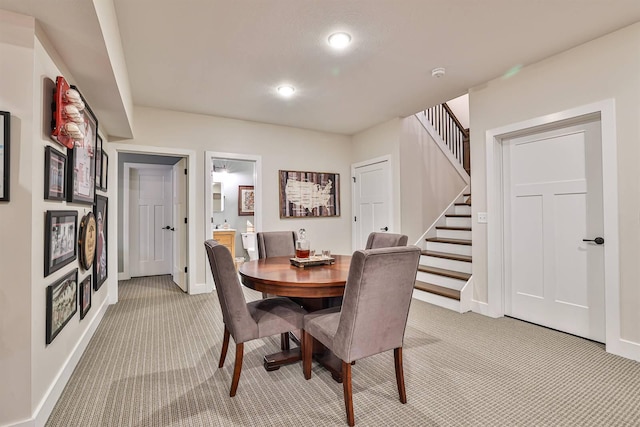 1439 Legacy Ct, Troy, OH 45373 - dining area with light colored carpet, stairs, and recessed lighting