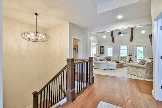 1439 Legacy Ct, Troy, OH 45373 - hallway featuring an upstairs landing, plenty of natural light, wood finished floors, and a chandelier