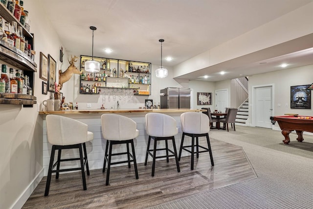 1439 Legacy Ct, Troy, OH 45373 - indoor wet bar with freestanding refrigerator, decorative light fixtures, stairs, billiards table, and recessed lighting