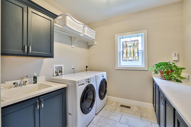 1439 Legacy Ct, Troy, OH 45373 - laundry area with cabinet space, washer and clothes dryer, and light tile patterned flooring