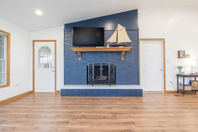 9342 State Route 368, Huntsville, OH 43324 - living area with lofted ceiling, a fireplace, wood finished floors, baseboards, and recessed lighting