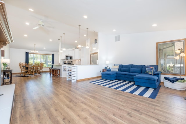 9342 State Route 368, Huntsville, OH 43324 - living room with vaulted ceiling, ceiling fan, light wood finished floors, and recessed lighting