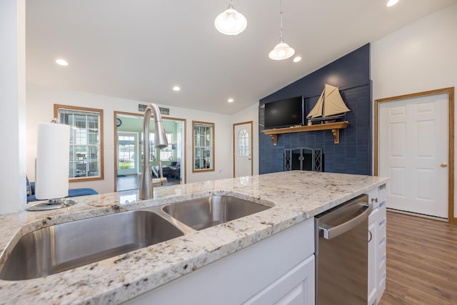9342 State Route 368, Huntsville, OH 43324 - kitchen with stainless steel dishwasher, a sink, lofted ceiling, wood finished floors, and white cabinets