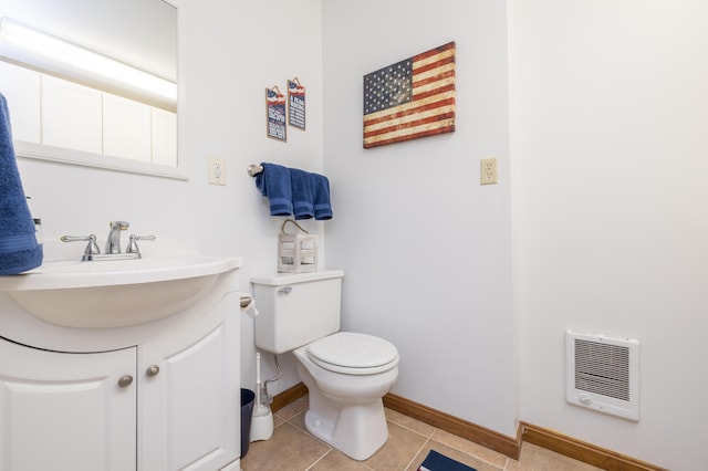 9342 State Route 368, Huntsville, OH 43324 - bathroom featuring heating unit, vanity, toilet, baseboards, and tile patterned flooring
