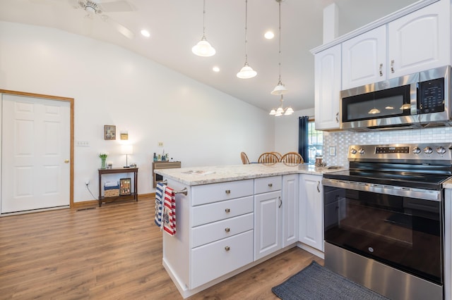 9342 State Route 368, Huntsville, OH 43324 - kitchen featuring appliances with stainless steel finishes, a peninsula, lofted ceiling, white cabinets, and light wood finished floors