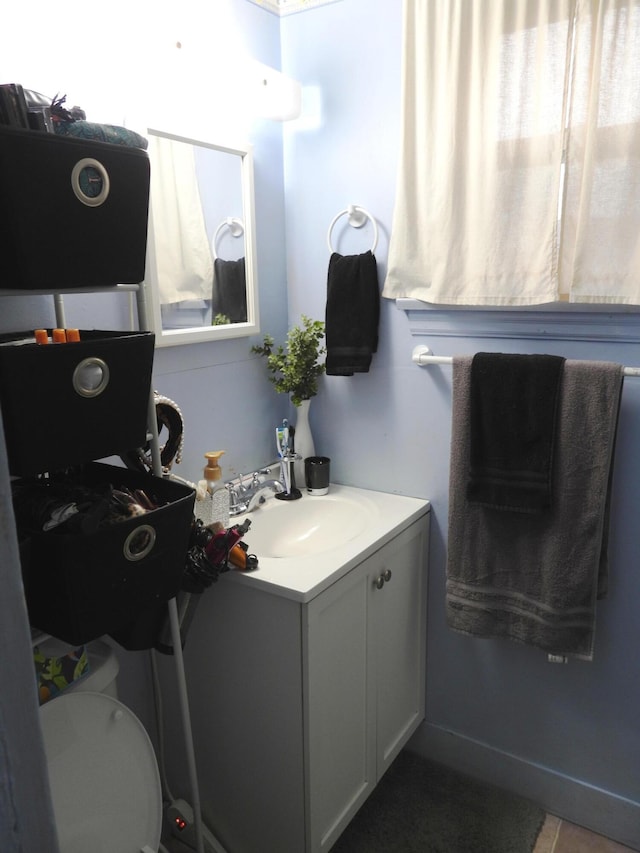 bathroom featuring vanity and toilet