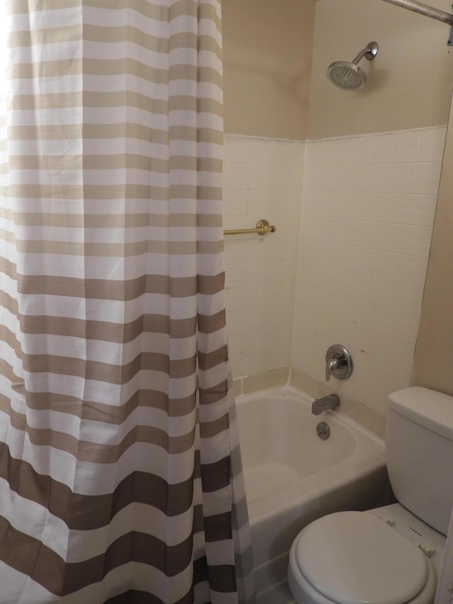 bathroom featuring shower / bathtub combination with curtain and toilet