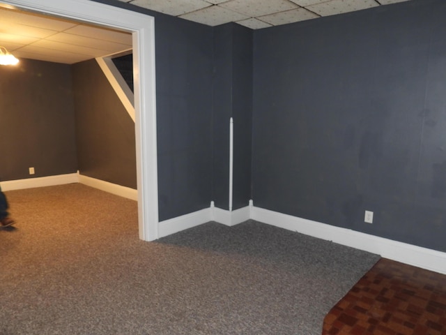 basement with carpet floors and a paneled ceiling