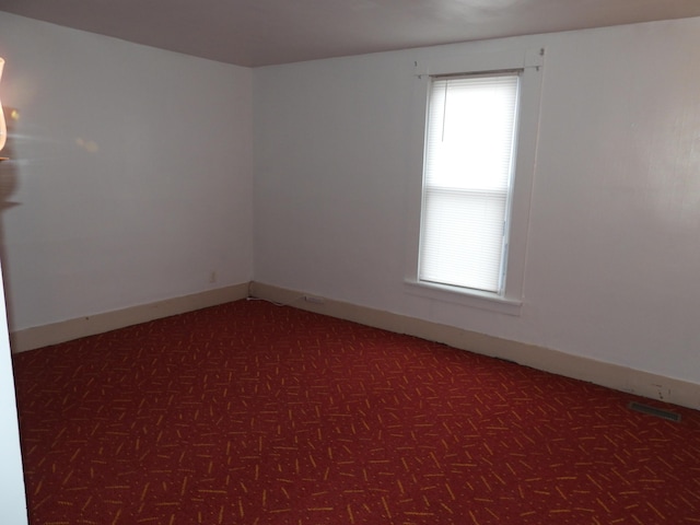 unfurnished room featuring dark parquet flooring