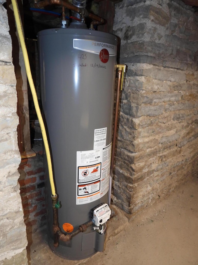 utility room featuring water heater