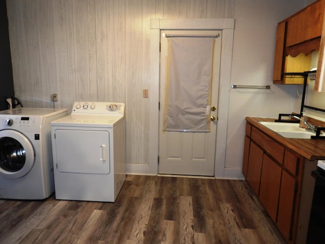 laundry area with dark hardwood / wood-style floors, sink, cabinets, and independent washer and dryer