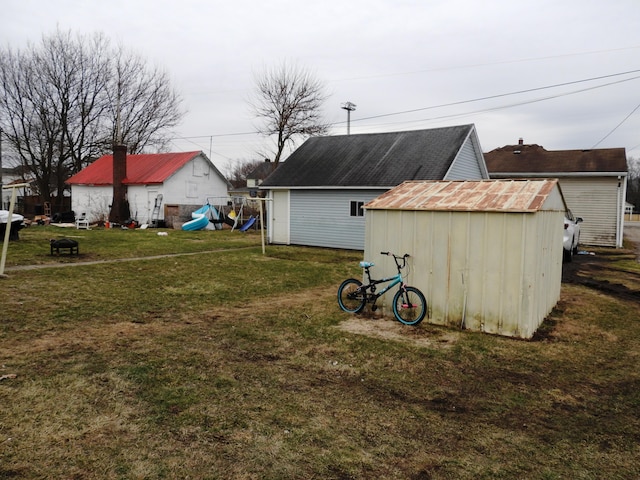 view of yard with a playground and a storage shed